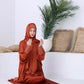  A lady praying with rusty orange abaya